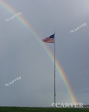  True Colors
An American Flag snaps furiously in the winds of a passing
thunderstorm as a rainbow brightens a dark and murky sky.
Keywords: rainbow; flag; wind; color; Beverly; art; photograph; picture; print